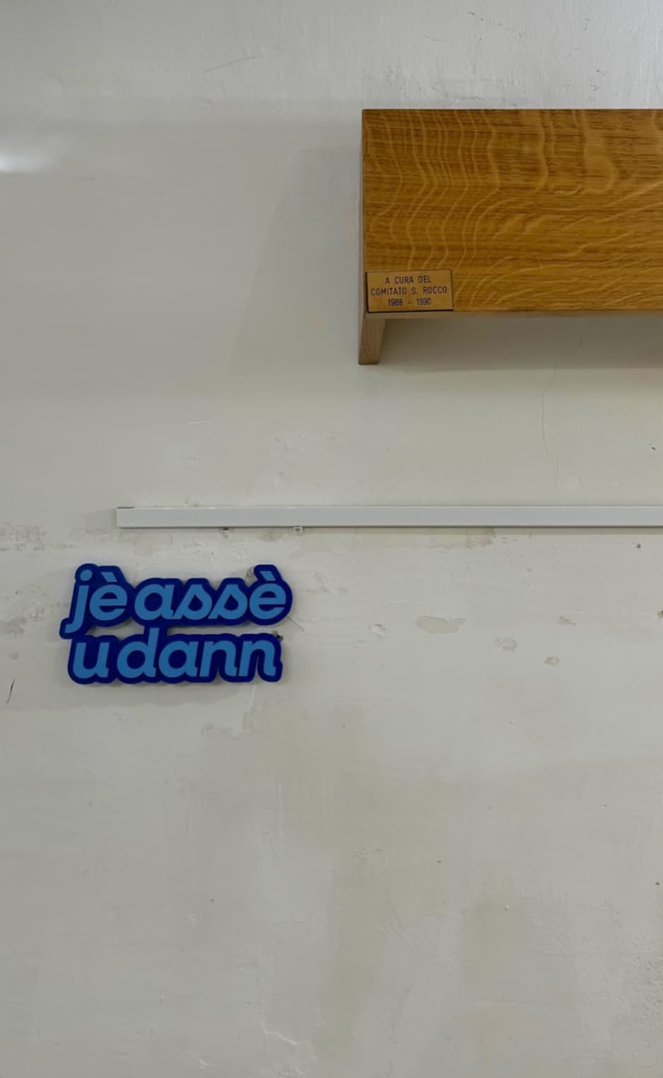 Blue Notami sign hanging on a white wall