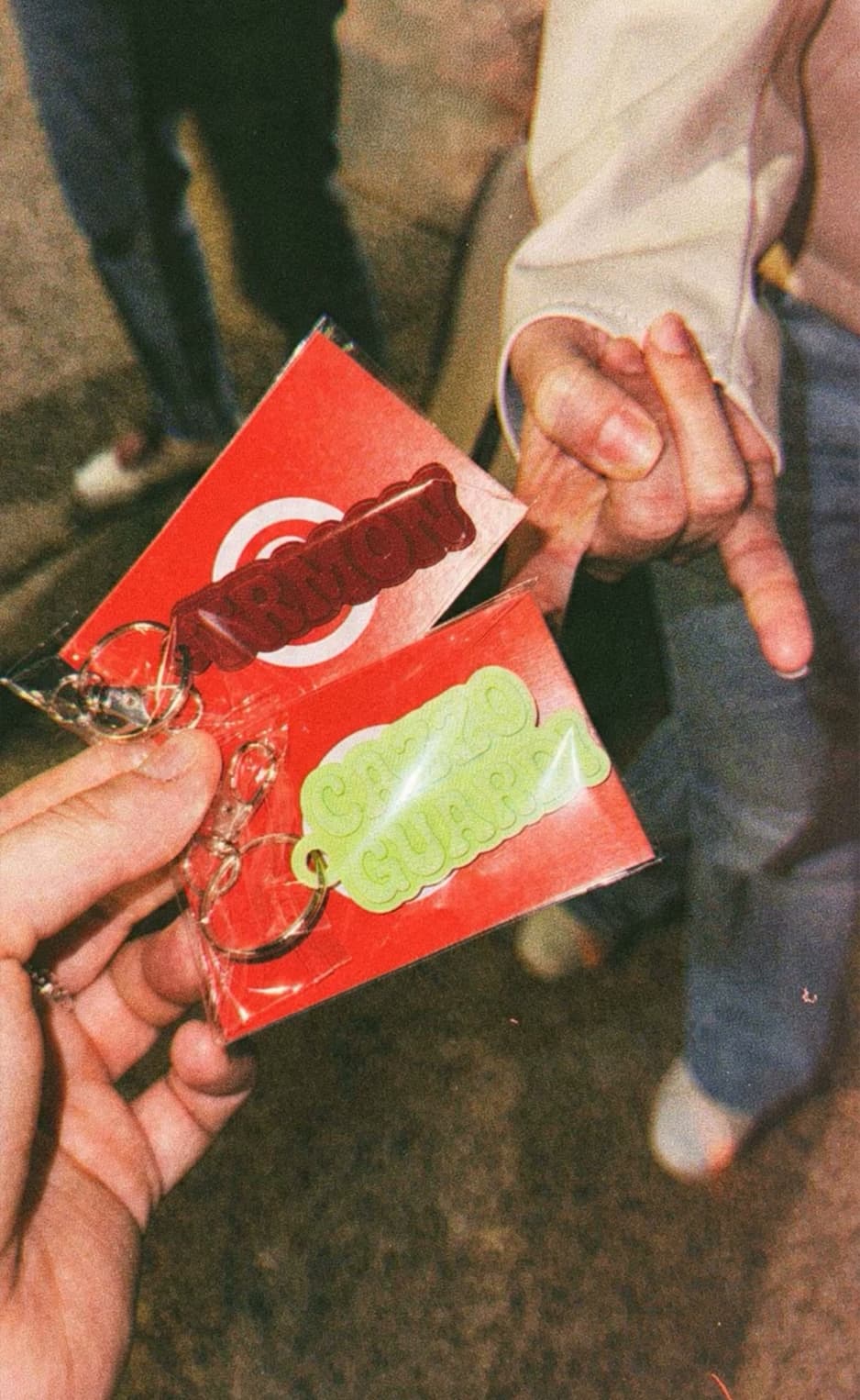 Two colourful keychains held in front of Notami cards
